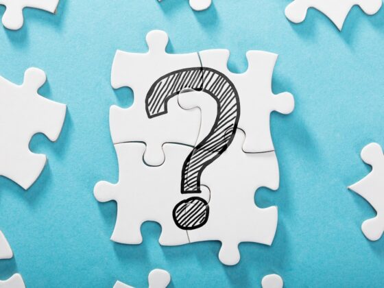 Elevated View Of Question Mark Icon On White Puzzle Over The Blue Background